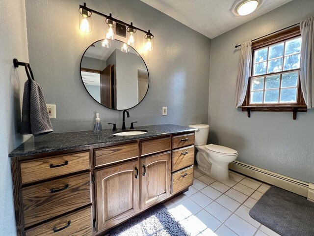 17 Park Dr, Villa Grove, IL 61956 - bathroom featuring a baseboard radiator, tile patterned floors, and vanity