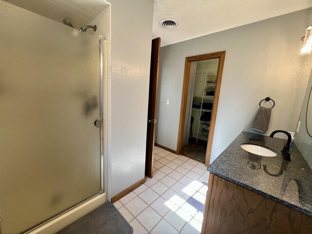 17 Park Dr, Villa Grove, IL 61956 - full bathroom featuring a shower stall, tile patterned floors, double vanity, and a spacious closet