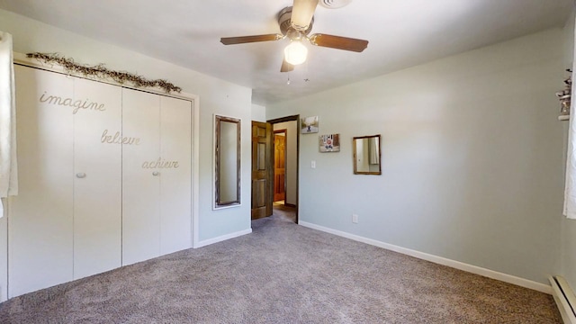 17 Park Dr, Villa Grove, IL 61956 - unfurnished bedroom with carpet, baseboard heating, a closet, and a ceiling fan
