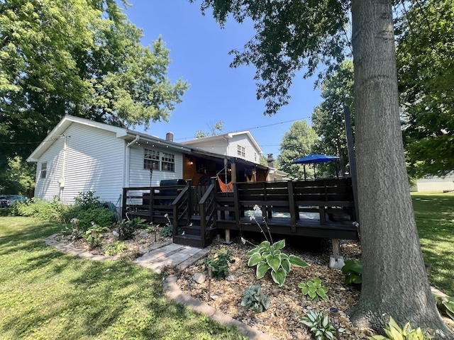 17 Park Dr, Villa Grove, IL 61956 - rear view of property featuring a lawn and a deck