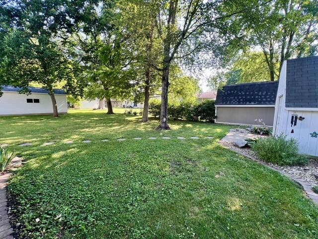 17 Park Dr, Villa Grove, IL 61956 - view of grassy yard featuring a storage unit