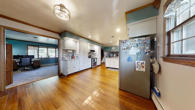 17 Park Dr, Villa Grove, IL 61956 - kitchen with stainless steel appliances, white cabinetry, a baseboard heating unit, an office area, and light wood-type flooring