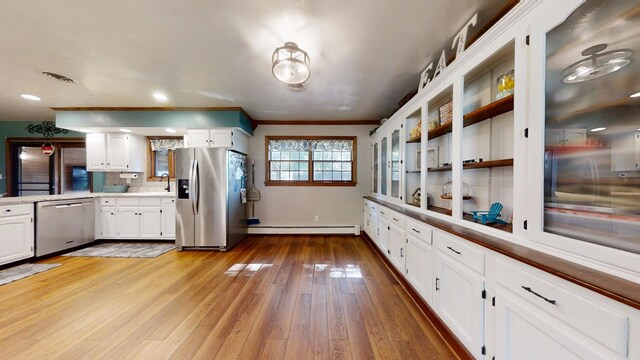 17 Park Dr, Villa Grove, IL 61956 - kitchen featuring appliances with stainless steel finishes, a baseboard radiator, light wood finished floors, white cabinetry, and light countertops