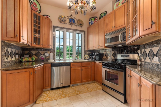 1130 Gavin Ct, Lake Forest, IL 60045 - kitchen featuring stainless steel appliances, brown cabinetry, and decorative backsplash
