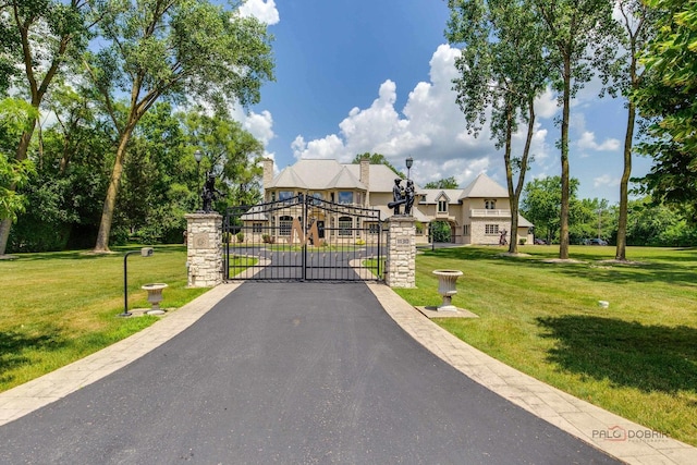 1130 Gavin Ct, Lake Forest, IL 60045 - view of front of house featuring a gate, stucco siding, a front lawn, and a chimney