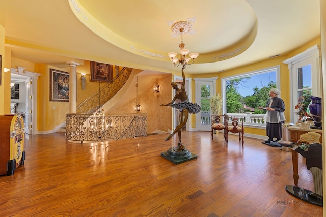 1130 Gavin Ct, Lake Forest, IL 60045 - exercise room featuring a chandelier, wood finished floors, decorative columns, and a raised ceiling