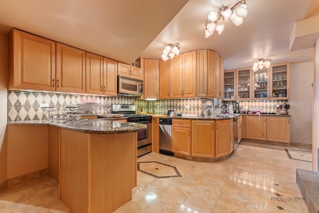 1130 Gavin Ct, Lake Forest, IL 60045 - kitchen featuring stainless steel appliances, a peninsula, dark stone countertops, tasteful backsplash, and glass insert cabinets