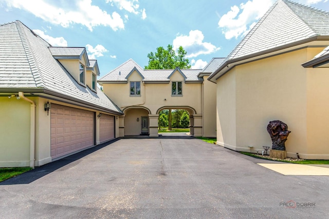 1130 Gavin Ct, Lake Forest, IL 60045 - view of front of house featuring stucco siding, asphalt driveway, and a high end roof