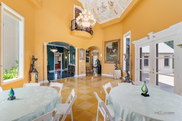 1130 Gavin Ct, Lake Forest, IL 60045 - tiled dining area featuring arched walkways, a chandelier, a high ceiling, and plenty of natural light