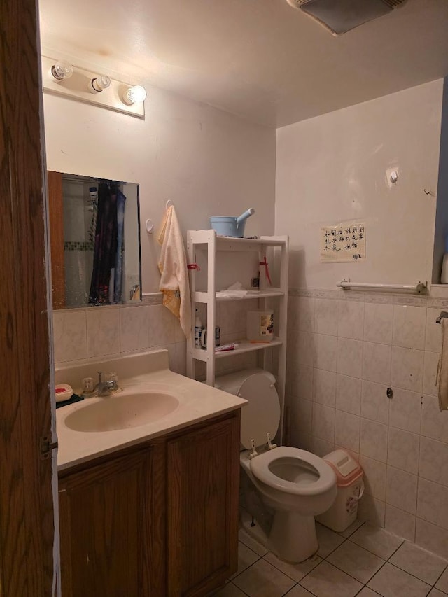 251 W 24th St Unit 1, Chicago, IL 60616 - bathroom with tile walls, vanity, tile patterned flooring, and a wainscoted wall