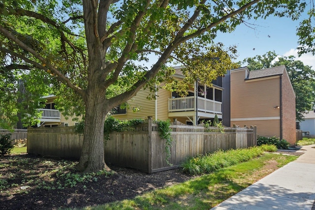 1521 S County Farm Rd Unit 2-2, Wheaton, IL 60189 - view of home's exterior with a fenced front yard and a balcony