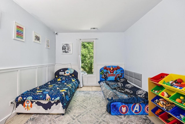 1521 S County Farm Rd Unit 2-2, Wheaton, IL 60189 - bedroom with wood finished floors and a wainscoted wall