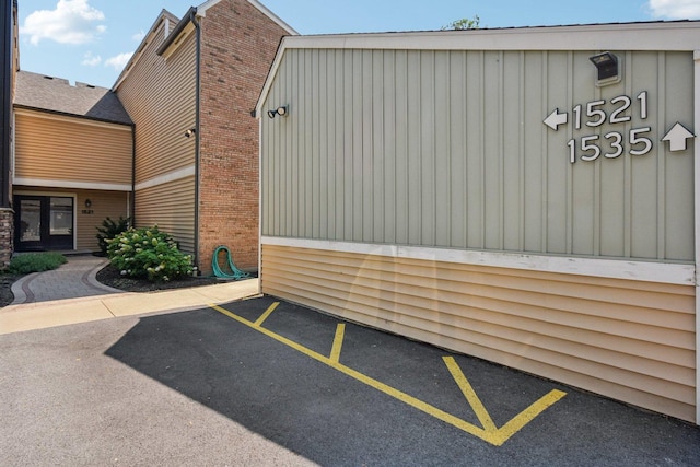 1521 S County Farm Rd Unit 2-2, Wheaton, IL 60189 - view of home's exterior featuring uncovered parking and board and batten siding