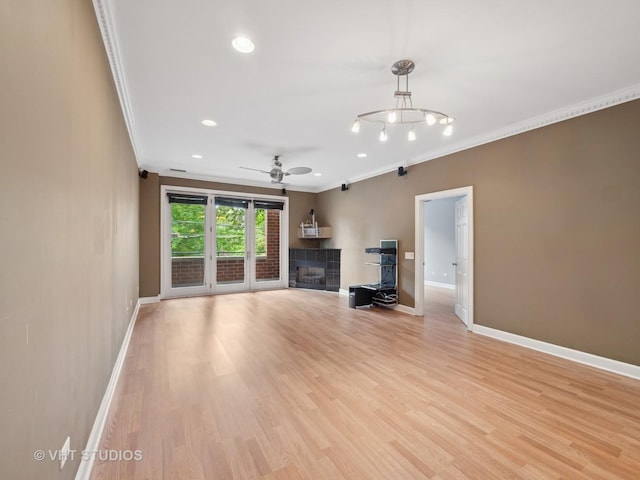 4553 N Magnolia Ave Unit 205, Chicago, IL 60640 - unfurnished living room with ornamental molding, ceiling fan, a tiled fireplace, recessed lighting, and light wood-type flooring