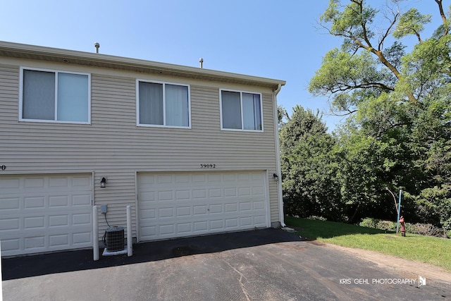 39092 Welsh Ln, Beach Park, IL 60083 - exterior space featuring an attached garage and asphalt driveway