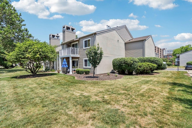 45 Orchard Ter Unit 7, Lombard, IL 60148 - rear view of property featuring a chimney, a yard, and a balcony