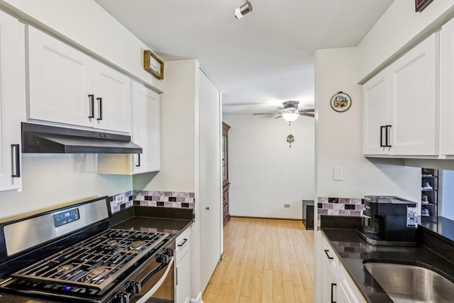 45 Orchard Ter Unit 7, Lombard, IL 60148 - kitchen with gas stove, under cabinet range hood, ceiling fan, white cabinets, and tasteful backsplash
