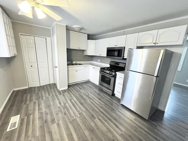 826 S Main St, Lombard, IL 60148 - kitchen with stainless steel appliances, ornamental molding, wood finished floors, white cabinets, and decorative backsplash