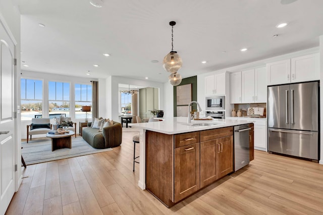 1063 Houston St Unit 89005, Batavia, IL 60510 - kitchen with stainless steel appliances, open floor plan, light wood-type flooring, white cabinetry, and recessed lighting