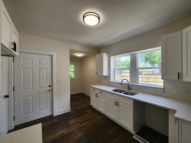 12416 S Carpenter St, Calumet Park, IL 60827 - kitchen with dark wood-style flooring, white cabinets, and light stone countertops