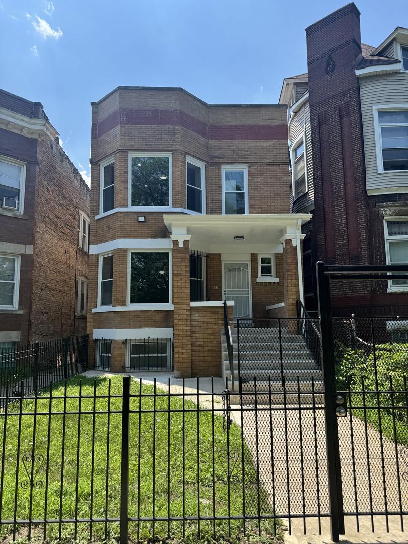 7204 S Union Ave, Chicago, IL 60621 - view of property with brick siding and a fenced front yard