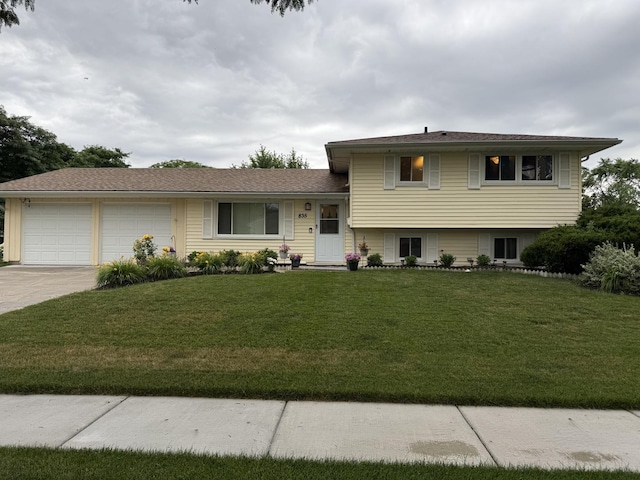 835 Williams Ct, Schaumburg, IL 60193 - split level home featuring an attached garage, a front lawn, and concrete driveway