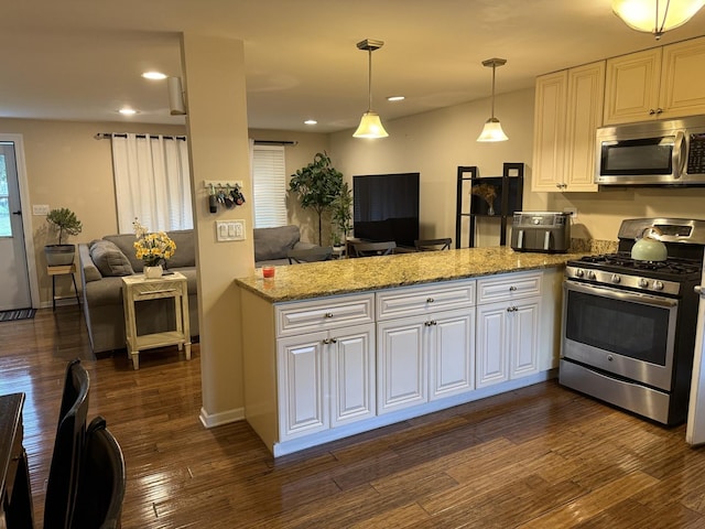 835 Williams Ct, Schaumburg, IL 60193 - kitchen featuring appliances with stainless steel finishes, open floor plan, a peninsula, white cabinetry, and recessed lighting