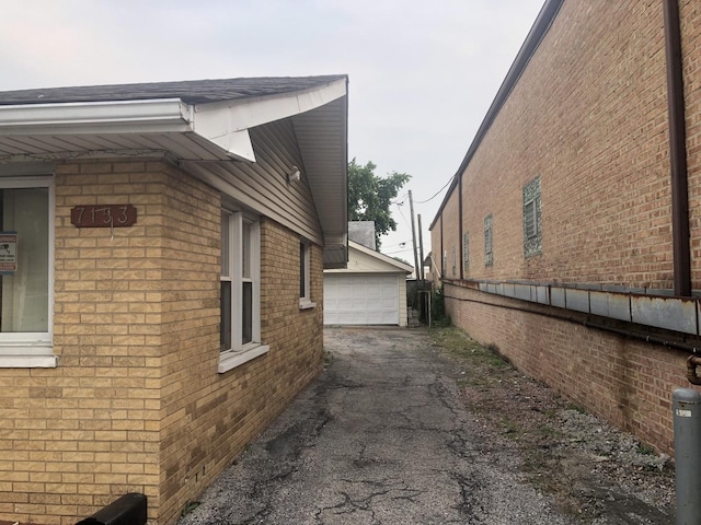 7153 W 72nd St, Nottingham Park, IL 60638 - view of property exterior with brick siding, a garage, and an outdoor structure