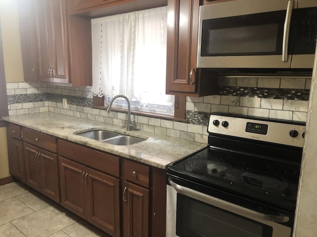 7153 W 72nd St, Nottingham Park, IL 60638 - kitchen with stainless steel appliances, backsplash, light tile patterned floors, and light stone countertops