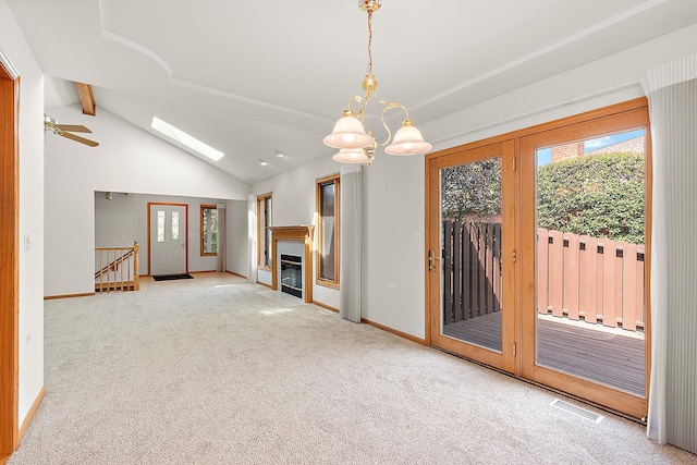 10509 San Luis Ln, Orland Park, IL 60467 - unfurnished living room featuring carpet, ceiling fan, a tiled fireplace, and a chandelier