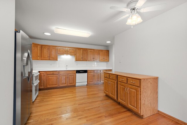 10509 San Luis Ln, Orland Park, IL 60467 - kitchen with white appliances, light wood-style flooring, light countertops, brown cabinets, and backsplash
