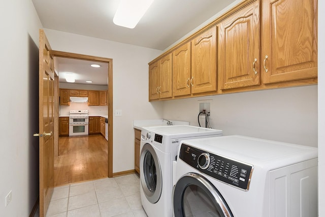 10509 San Luis Ln, Orland Park, IL 60467 - laundry area with cabinet space, separate washer and dryer, recessed lighting, and light tile patterned floors
