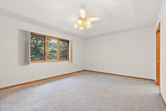 10509 San Luis Ln, Orland Park, IL 60467 - spare room featuring carpet floors, a ceiling fan, and a raised ceiling