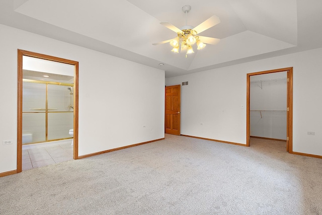 10509 San Luis Ln, Orland Park, IL 60467 - unfurnished bedroom with light carpet, a walk in closet, a closet, connected bathroom, and a raised ceiling