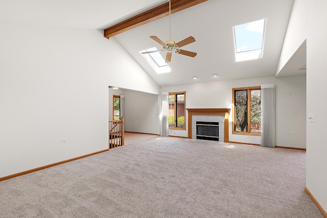 10509 San Luis Ln, Orland Park, IL 60467 - unfurnished living room featuring a skylight, high vaulted ceiling, beamed ceiling, carpet floors, and a ceiling fan