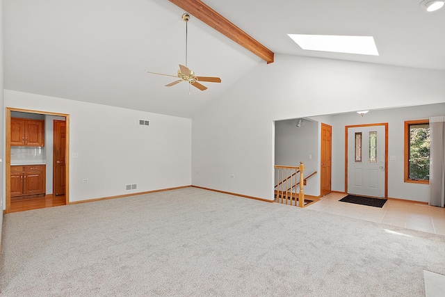 10509 San Luis Ln, Orland Park, IL 60467 - unfurnished living room with a skylight, light colored carpet, beam ceiling, ceiling fan, and high vaulted ceiling