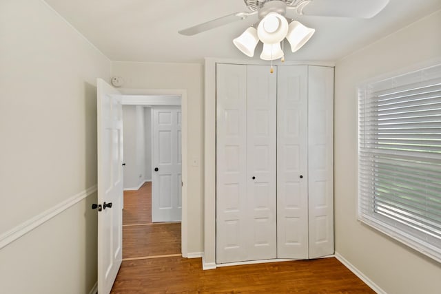 7523 Bristol Ln Unit A, Hanover Park, IL 60133 - unfurnished bedroom with wood finished floors, a closet, and a ceiling fan