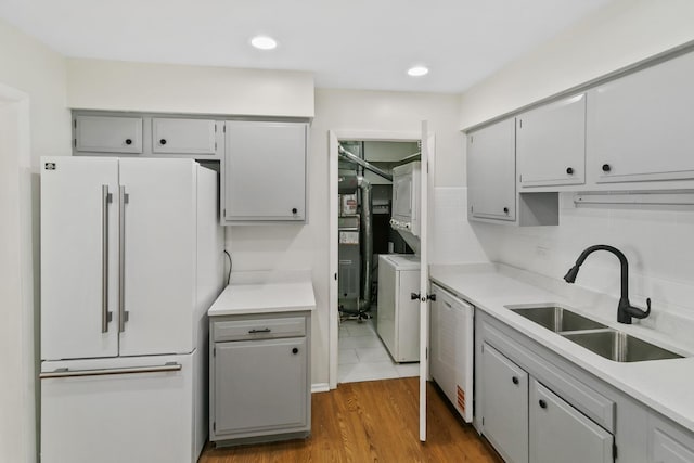 7523 Bristol Ln Unit A, Hanover Park, IL 60133 - kitchen featuring white appliances, stacked washing machine and dryer, gray cabinetry, light countertops, and recessed lighting
