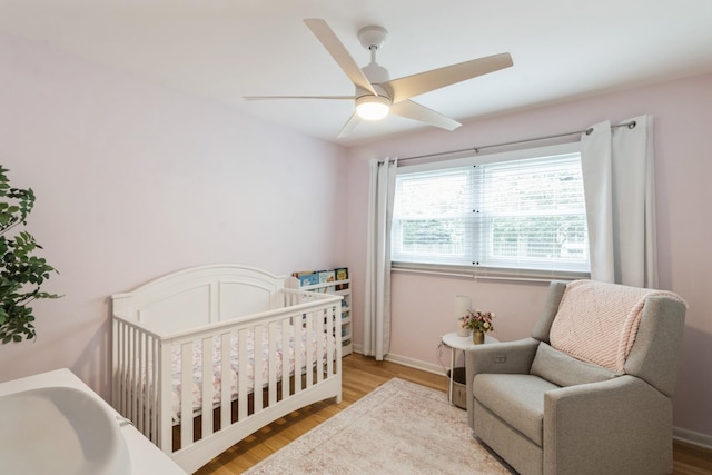 639 N Stephen Dr, Palatine, IL 60067 - bedroom with wood finished floors, ceiling fan, and a crib