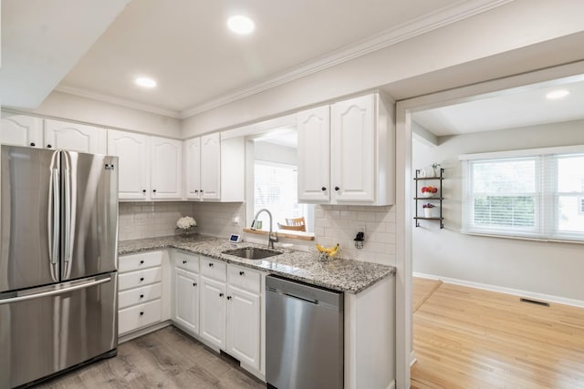 639 N Stephen Dr, Palatine, IL 60067 - kitchen with stainless steel appliances, light wood finished floors, light stone countertops, tasteful backsplash, and white cabinetry