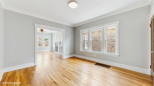 5041 W Fletcher St, Chicago, IL 60641 - unfurnished room with light wood-style flooring, ornamental molding, and a ceiling fan