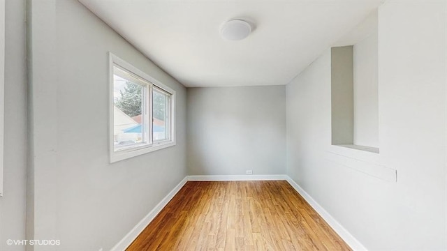 5041 W Fletcher St, Chicago, IL 60641 - empty room featuring wood finished floors and baseboards
