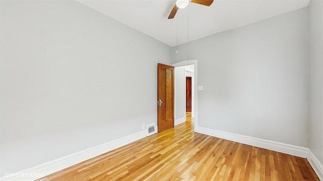 5041 W Fletcher St, Chicago, IL 60641 - empty room with light wood-style floors and ceiling fan