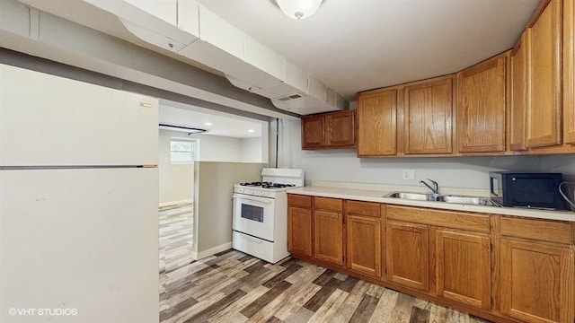 5041 W Fletcher St, Chicago, IL 60641 - kitchen featuring white appliances, light wood-type flooring, light countertops, and brown cabinets