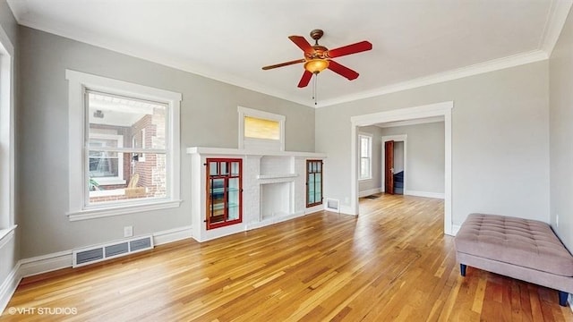 5041 W Fletcher St, Chicago, IL 60641 - unfurnished living room featuring light wood-style flooring, ceiling fan, and ornamental molding
