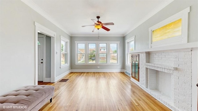 5041 W Fletcher St, Chicago, IL 60641 - unfurnished living room with a ceiling fan, light wood finished floors, ornamental molding, and a fireplace