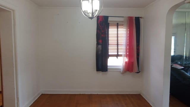 3512 W 84th St, Chicago, IL 60652 - spare room featuring arched walkways, wood finished floors, a chandelier, plenty of natural light, and ornamental molding