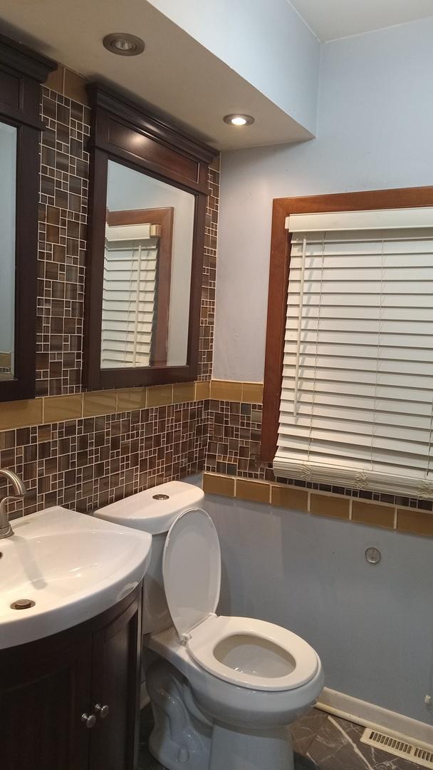 3512 W 84th St, Chicago, IL 60652 - half bathroom with vanity and decorative backsplash