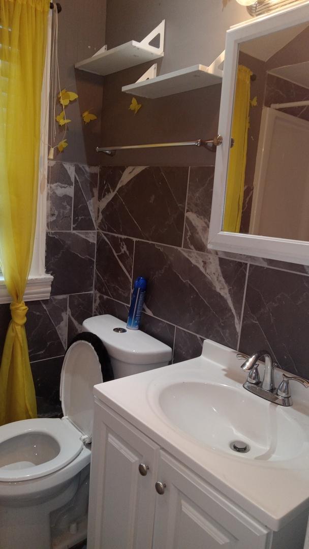 3512 W 84th St, Chicago, IL 60652 - bathroom with vanity, tile walls, marble finish floors, and backsplash