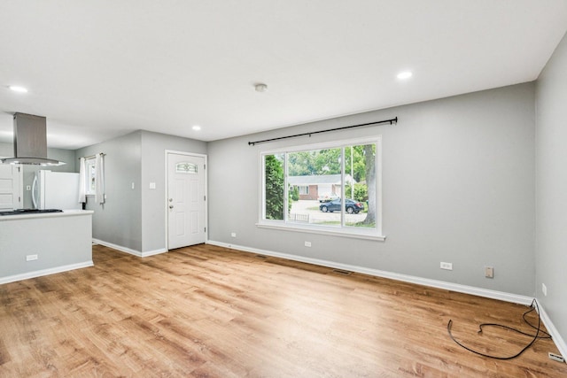 404 Virginia Pl, Wheeling, IL 60090 - unfurnished living room featuring light wood-style floors and recessed lighting